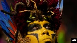 FILE - A performer from the Salgueiro samba school parades during Carnival celebrations at the Sambadrome in Rio de Janeiro, Brazil, February 12, 2024. 