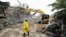 FILE: A rescue worker walks into the site of an under-construction building collapse, as they search for survivors in Oniru, Lagos, Nigeria. 9.24.2022