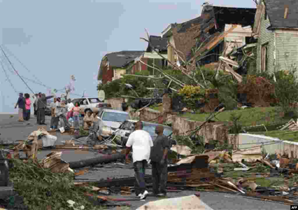 Residents survey the destruction after a tornado hit Pratt City, Ala. just north of downtown Birmingham, Ala., on Wednesday, April 27, 2011. A wave of severe storms laced with tornadoes strafed the South on Wednesday, killing at least 16 people around the