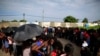 Mainly Haitian along with some African migrants wait in men's and women's lines to request documents giving them temporary legal status in Mexico, outside the Siglo XXI detention center in Tapachula, Mexico, June 12, 2019. 