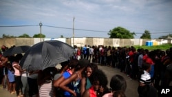 Mainly Haitian along with some African migrants wait in men's and women's lines to request documents giving them temporary legal status in Mexico, outside the Siglo XXI detention center in Tapachula, Mexico, June 12, 2019. 