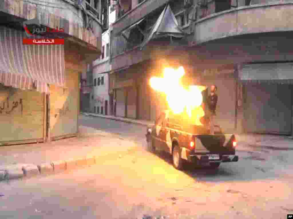 In this image taken from video from the Shaam News Network, fighters from the Free Syrian Army target regime forces in Aleppo, Syria, July 22, 2013.