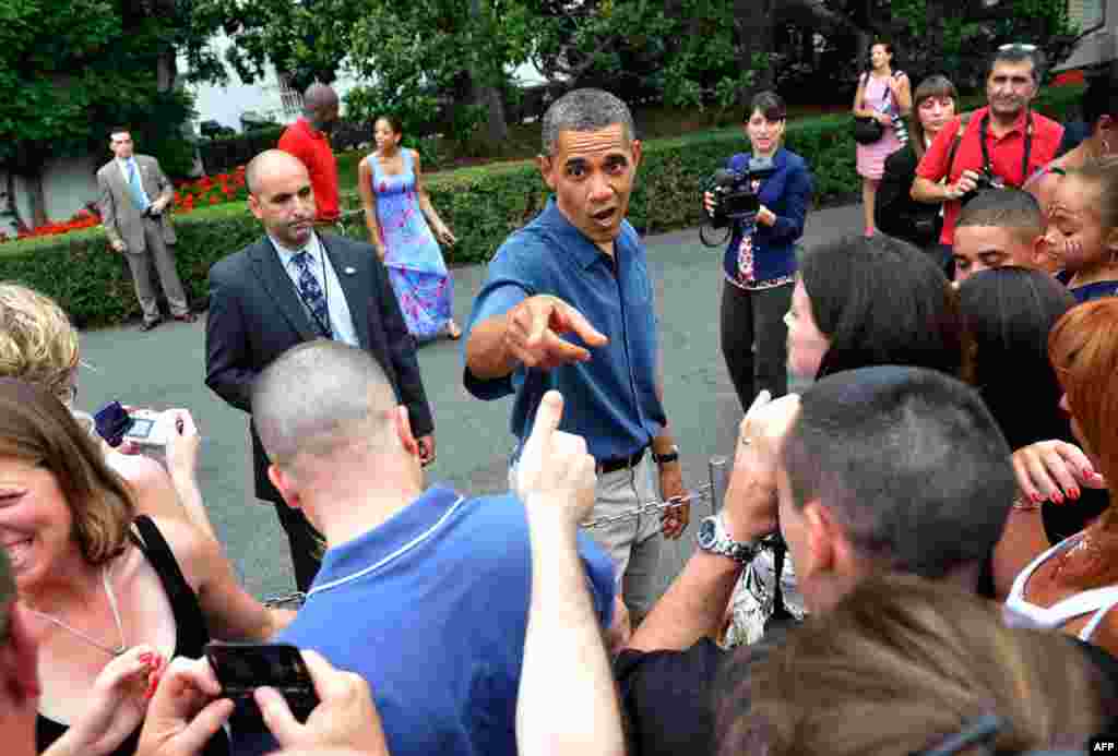 July 4: President Obama greets a fellow Chicagoan at an Independence Day barbeque for members of the military and their families on the South Lawn of the White House in Washington. REUTERS/Jonathan Ernst