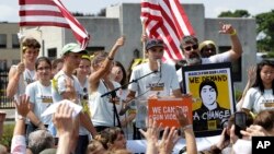 David Hogg (C) a survivor of the school shooting at Marjory Stoneman Douglas High School, in Parkland, Florida, addresses a rally in front of the headquarters of gun manufacturer Smith & Wesson, Aug. 26, 2018, in Springfield, Mass.