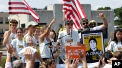 FILE - Activists, including some survivors of the school shooting at Marjory Stoneman Douglas High School, in Parkland, Florida, rally in front of the headquarters of gun manufacturer Smith & Wesson in Springfield, Mass., Aug. 26, 2018.