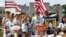 FILE - Activists, including some survivors of the school shooting at Marjory Stoneman Douglas High School, in Parkland, Florida, rally in front of the headquarters of gun manufacturer Smith & Wesson in Springfield, Mass., Aug. 26, 2018.