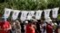 Protesters use baby cloths to display a message during an immigration really across from the federal courthouse in Brownsville, Texas, June 28, 2018.