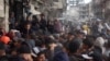 Palestinians line up to receive bread outside a bakery in Khan Yunis, Nov. 18, 2024, amid the ongoing war between Israel and Hamas.