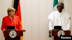 German Chancellor Angela Merkel and Nigeria's President Muhammadu Buhari address a news conference at the presidential villa in Abuja, Nigeria, Aug. 31, 2018.