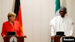 German Chancellor Angela Merkel and Nigeria's President Muhammadu Buhari address a news conference at the presidential villa in Abuja, Nigeria, Aug. 31, 2018.