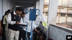 A doctor tends to alcohol poisoning patients receiving medical treatment at the Diamond Harbour sub-divisional hospital in Diamond Harbour, December 15, 2011.