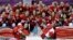 Team Canada gathers for a group photo after beating the USA 3-2 in overtime of the gold medal women's ice hockey game at the 2014 Winter Olympics, Feb. 19, 2014, in Sochi, Russia.