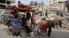 A Palestinian family relocates with their belongings in Beit Lahia, in the northern Gaza Strip on May 19, 2024, amid the ongoing conflict between Israel and the militant Hamas group.