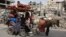 A Palestinian family relocates with their belongings in Beit Lahia, in the northern Gaza Strip on May 19, 2024, amid the ongoing conflict between Israel and the militant Hamas group.
