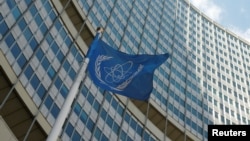 The flag of the International Atomic Energy Agency (IAEA) flies in front of IAEA's headquarters during a board of governors meeting in Vienna, Austria June 12, 2017. REUTERS