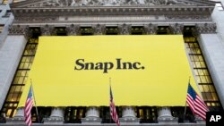 FILE - In this Thursday, March 2, 2017, file photo, a banner for Snap Inc. hangs from the front of the New York Stock Exchange, in New York. Chinese internet company Tencent buys a 10 percent stake in Snap, announced Wednesday, Nov. 8, 2017. 