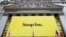 FILE - In this Thursday, March 2, 2017, file photo, a banner for Snap Inc. hangs from the front of the New York Stock Exchange, in New York. Chinese internet company Tencent buys a 10 percent stake in Snap, announced Wednesday, Nov. 8, 2017. 
