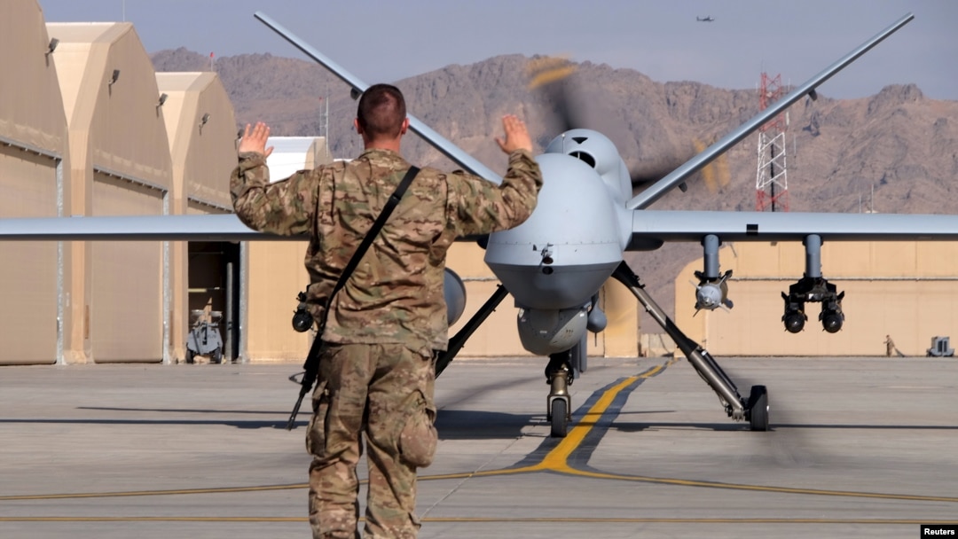 A U.S. airman guides a U.S. Air Force MQ-9 Reaper drone as it taxis to the runway at Kandahar Airfield, Afghanistan March 9, 2016.