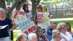 FILE - Demonstrators gather for an anti-mask rally in Orem, Utah, Aug. 5, 2020.