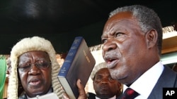 Zambia's new President Michael Sata, right, takes the oath of office on the steps of the supreme court in Lusaka, September 23, 2011.
