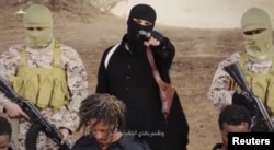FILE - An Islamic State militant holds a gun while standing behind what are said to be Ethiopian Christians in Wilayat Fazzan, Libya, in this still image from an undated video made available on a social media website on April 19, 2015.