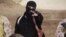 FILE - An Islamic State militant holds a gun in this still image from an undated video made available on a social media website on April 19, 2015. 