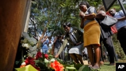 People lay flowers in honor of the dead outside the gate of the dusitD2 hotel complex which was attacked last week, at a wreath-laying event organized by the hotel complex management in Nairobi, Kenya, Jan. 22, 2019. 
