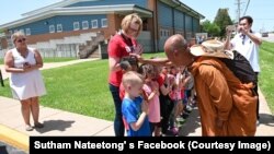 Children line up to meet and greet Buddhist monk Sutham Nateetong at Ziztman Elementary School during his journey walk across America to promote peace in Pacific, Missouri. May 22, 2019. 