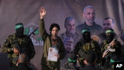 Israeli Ofer Kalderon, who has been held hostage by Hamas in Gaza since Oct. 7, 2023, waves before being handed over to the Red Cross by Hamas fighters in Khan Younis, southern Gaza Strip, Feb. 1, 2025.