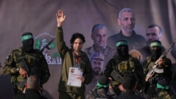Israeli Ofer Kalderon, who has been held hostage by Hamas in Gaza since Oct. 7, 2023, waves before being handed over to the Red Cross by Hamas fighters in Khan Younis, southern Gaza Strip, Feb. 1, 2025.