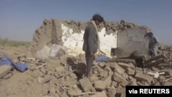People rummage through rubble after an airstrike in Al-Jawf province, Yemen, Feb. 15, 2020, in this image taken from a video. (Houthi Media Centre/via REUTERS)