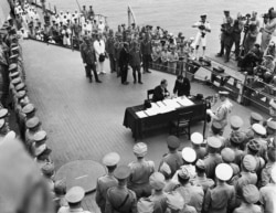 FILE - Japan's delegation gather to sign the formal surrender document on the U.S. Navy battleship USS Missouri in Tokyo Bay, Sept. 2, 1945. (US Navy/Handout via Reuters)