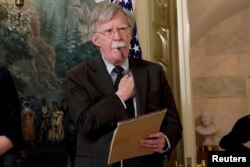 FILE - Former National Security Adviser John Bolton listens to U.S. President Donald Trump's statement on Syria at the White House in Washington, April 13, 2018.