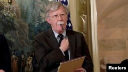 FILE - Former National Security Adviser John Bolton listens to U.S. President Donald Trump's statement on Syria at the White House in Washington, April 13, 2018.