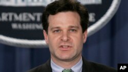 FILE - Christopher Wray speaks at a press conference at the Justice Department in Washington. 