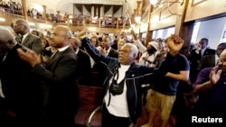 The Rev. Sandy Drayton reacts during a prayer vigil held at the African Methodist Episcopal Church in Charleston, South Carolina, June 18, 2015. 