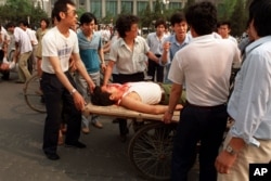 Local residents loaded the wounded people on a rickshaw flatbed shortly after PLA soldiers opened fire on a crowd in this June 4, 1989 photo.