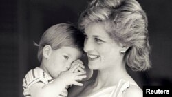 FILE - Britain's Princess Diana holds Prince Harry during a morning picture session at Marivent Palace, where the Prince and Princess of Wales are holidaying as guests of King Juan Carlos and Queen Sofia, in Mallorca, Spain Aug. 9, 1988. 