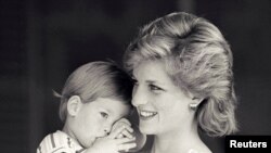 FILE - Britain's Princess Diana holds Prince Harry during a morning picture session at Marivent Palace, where the Prince and Princess of Wales are holidaying as guests of King Juan Carlos and Queen Sofia, in Mallorca, Spain August 9, 1988. 