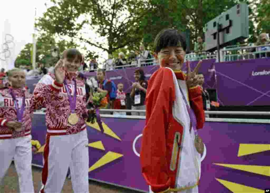 Poses for the photos after earning the bronze medal in the women&#39;s 20-kilometer race walk at the 2012 Summer Olympics, Saturday, Aug. 11, 2012, in London. Russia&#39;s Elena Lashmanova won the gold medal and Russia&#39;s Olga Kani