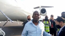 A U.S. agent removes handcuffs from Rwanda genocide suspect Oswald Rurangwa after he is flown by U.S. authorities to Kigali on Oct. 7, 2021, for transfer to Rwandan police custody. (Assumpta Kagoyi/VOA Central Africa Service)