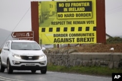 FILE - A motorist crosses over the border from the Irish Republic into Northern Ireland near the town of Jonesborough, Northern Ireland, Jan. 30, 2017.