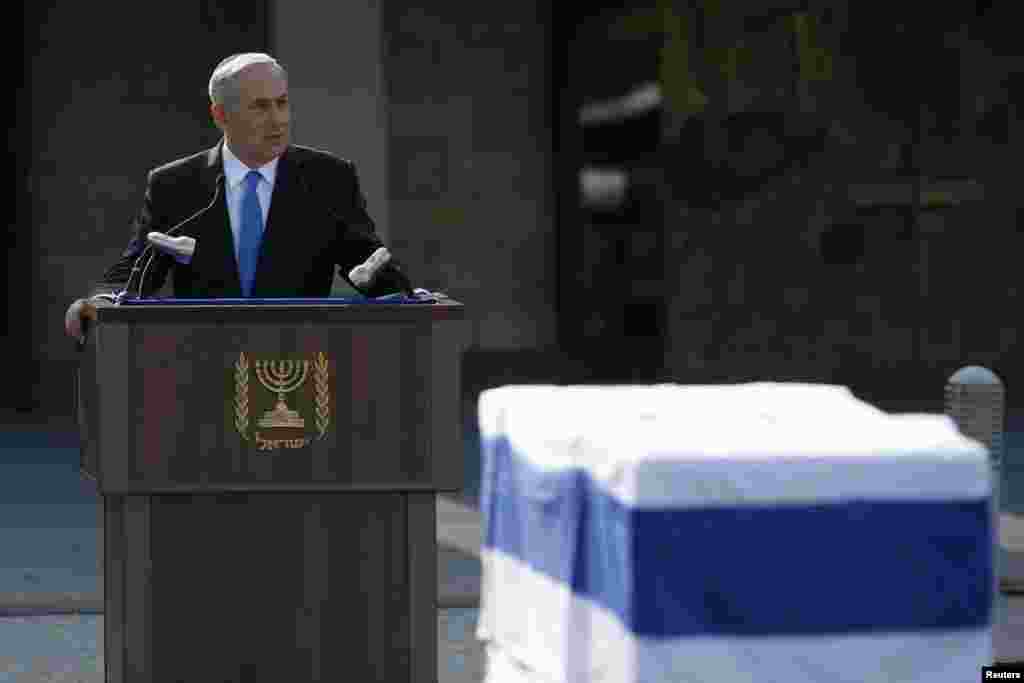 Israel&#39;s Prime Minister Benjamin Netanyahu speaks near the flag draped coffin of former Prime Minister Ariel Sharon during a memorial ceremony at Israel&#39;s parliament in Jerusalem, Jan. 13, 2014.
