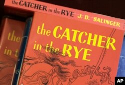FILE - Copies of J.D. Salinger's classic novel "The Catcher in the Rye" are seen at the Orange Public Library in Orange Village, Ohio, Jan. 28, 2010.