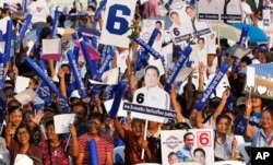 Supporters of the Palang Pracharat Party cheer during an election campaign rally ahead of Sunday's general election in Bangkok, Thailand, Friday, March 22, 2019.