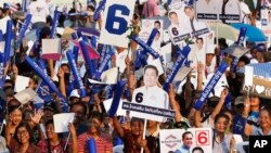 Supporters of the Palang Pracharat Party cheer during an election campaign rally ahead of Sunday's general election in Bangkok, Thailand, Friday, March 22, 2019. The nation's first general election since the military seized power in a 2014 coup is expecte