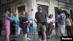 American tourists look around during a tour at old Havana, Cuba December 14, 2015.