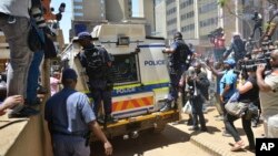 A heavily guarded vehicle carries Oscar Pistorius to prison, Pretoria, South Africa, Oct. 21, 2014.