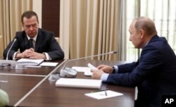 Russian President Vladimir Putin, right, meets with his Prime Minister Dmitry Medvedev, Moscow, Wednesday, July 5, 2017.