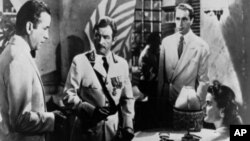 A scene from the 1942 film "Casablanca" with Ingrid Bergman, lower right, Humphrey Bogart, far left, Claude Raines, center, and Paul Henreid, right background.